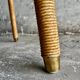Natural Lloyd Loom paper cord rattan round table with brass-capped legs by Vincent Sheppard