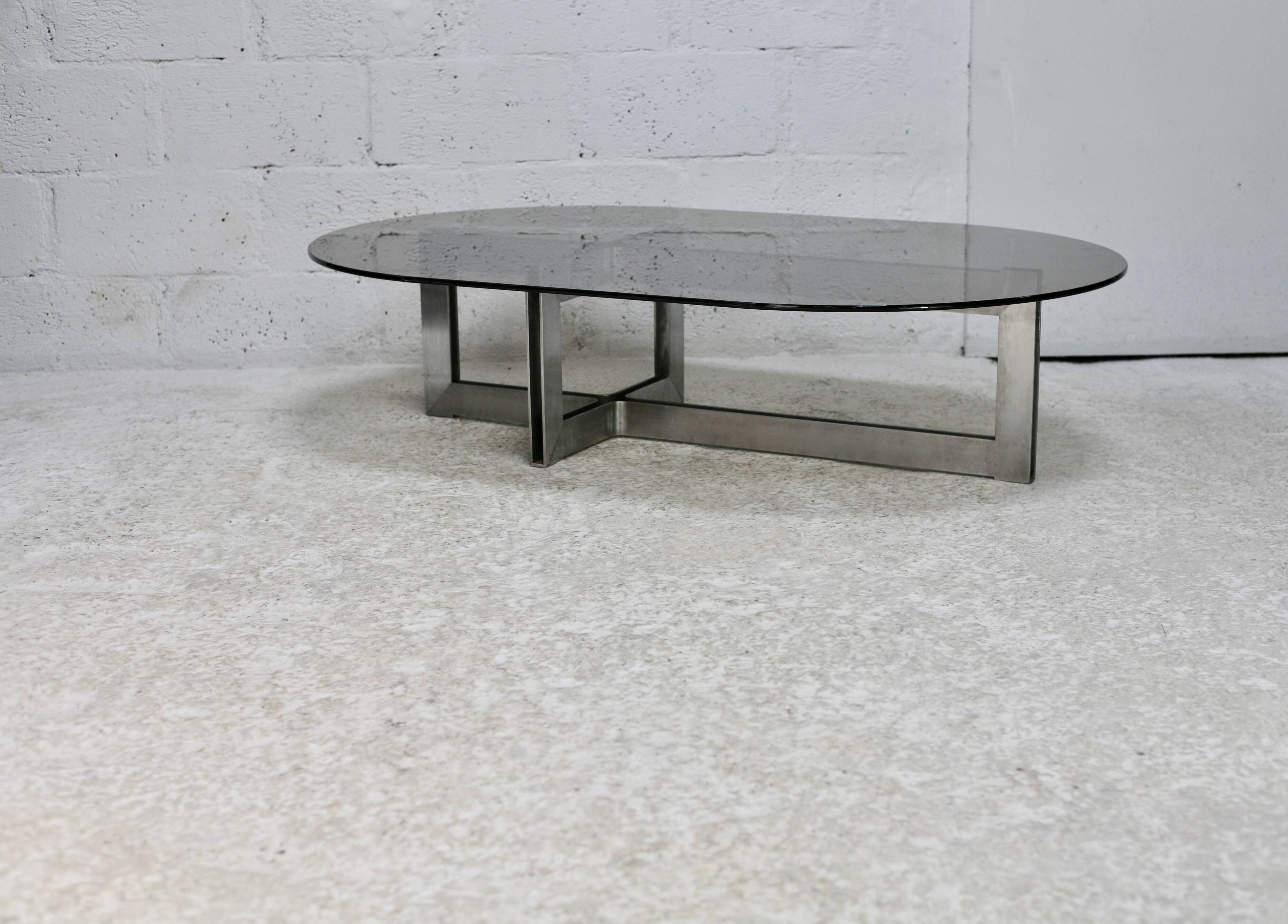 Coffee table with steel base and smoked glass slab. Circa 197