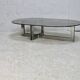 Coffee table with steel base and smoked glass slab. Circa 197