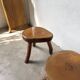 Set of three rustic solid wood tripod stools.