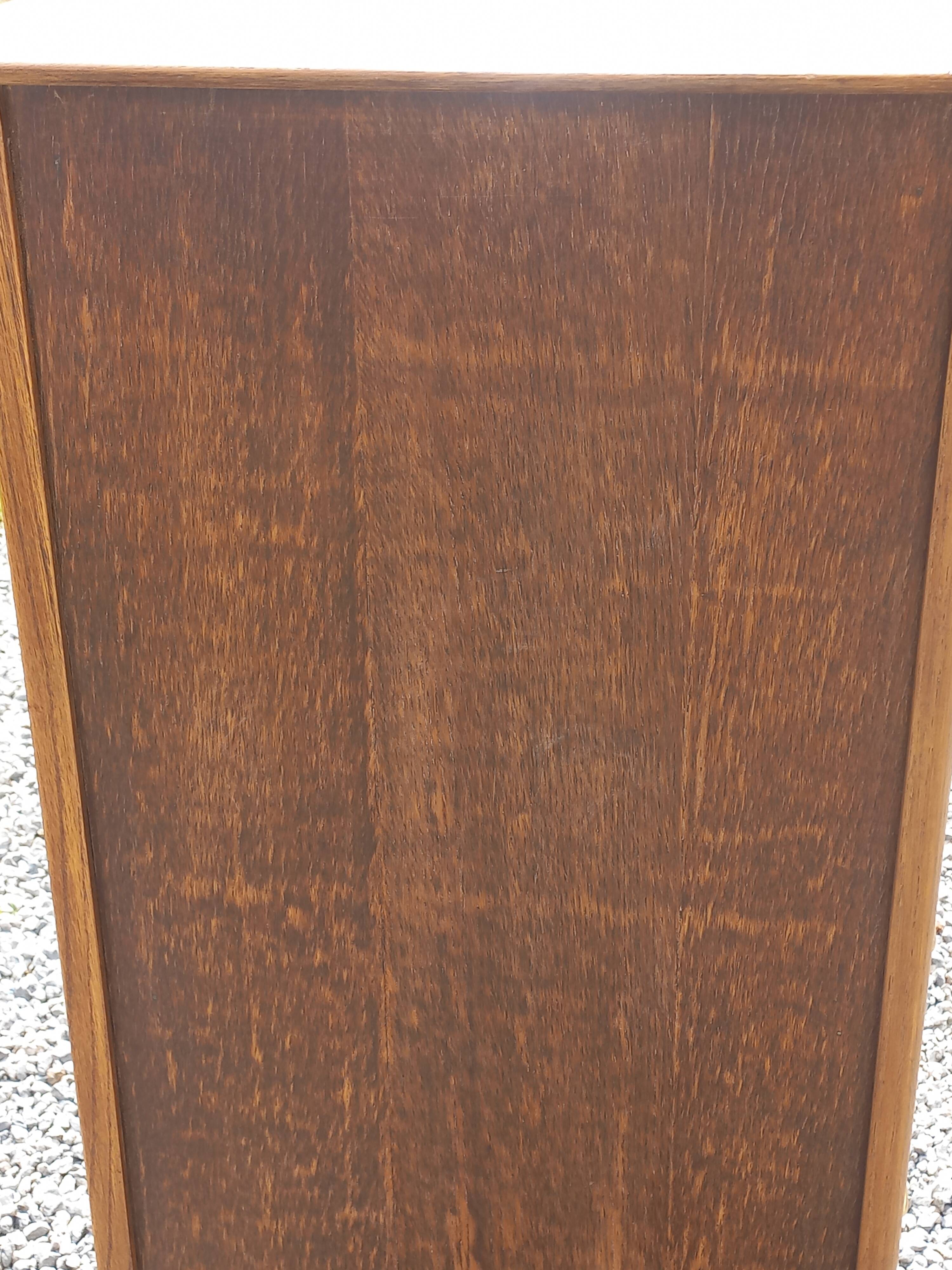 Vintage oak chest of drawers with tapered legs from the 1950s.