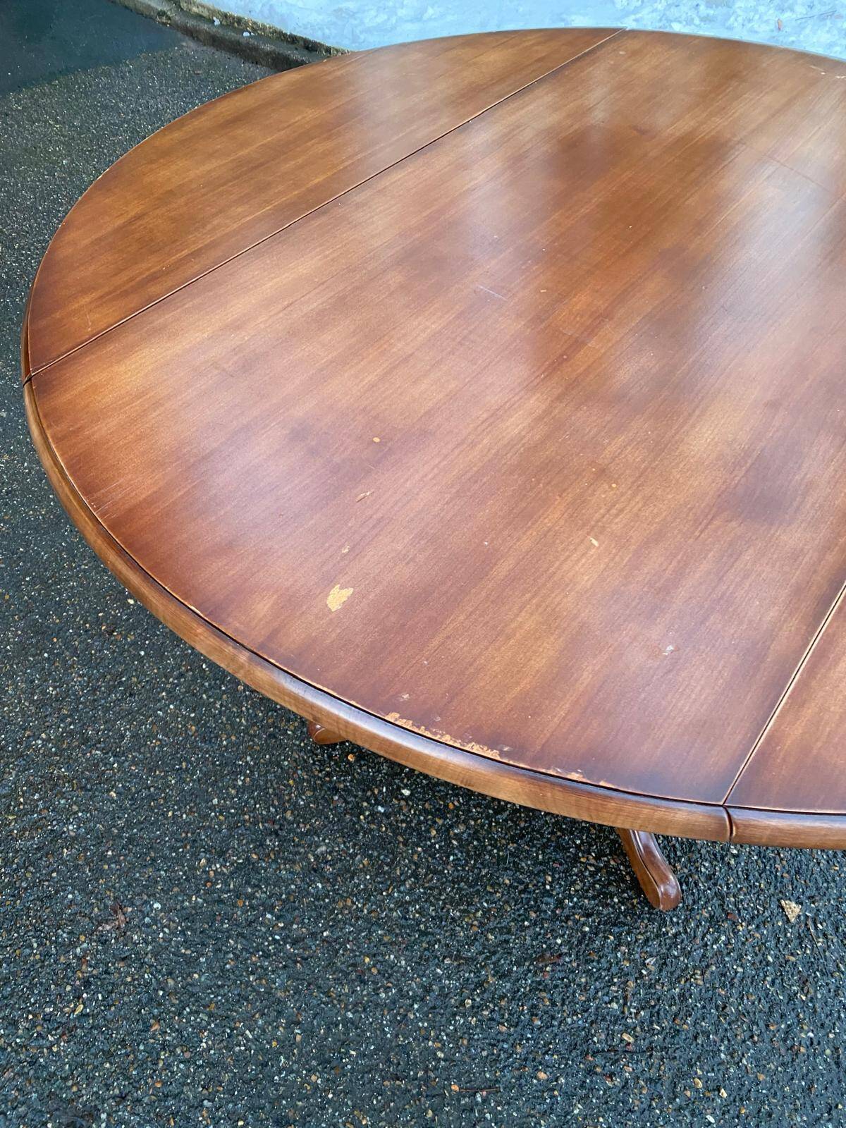Round dining table, solid wood, central leg, extendable flaps, 20th century.
