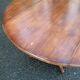 Round dining table, solid wood, central leg, extendable flaps, 20th century.
