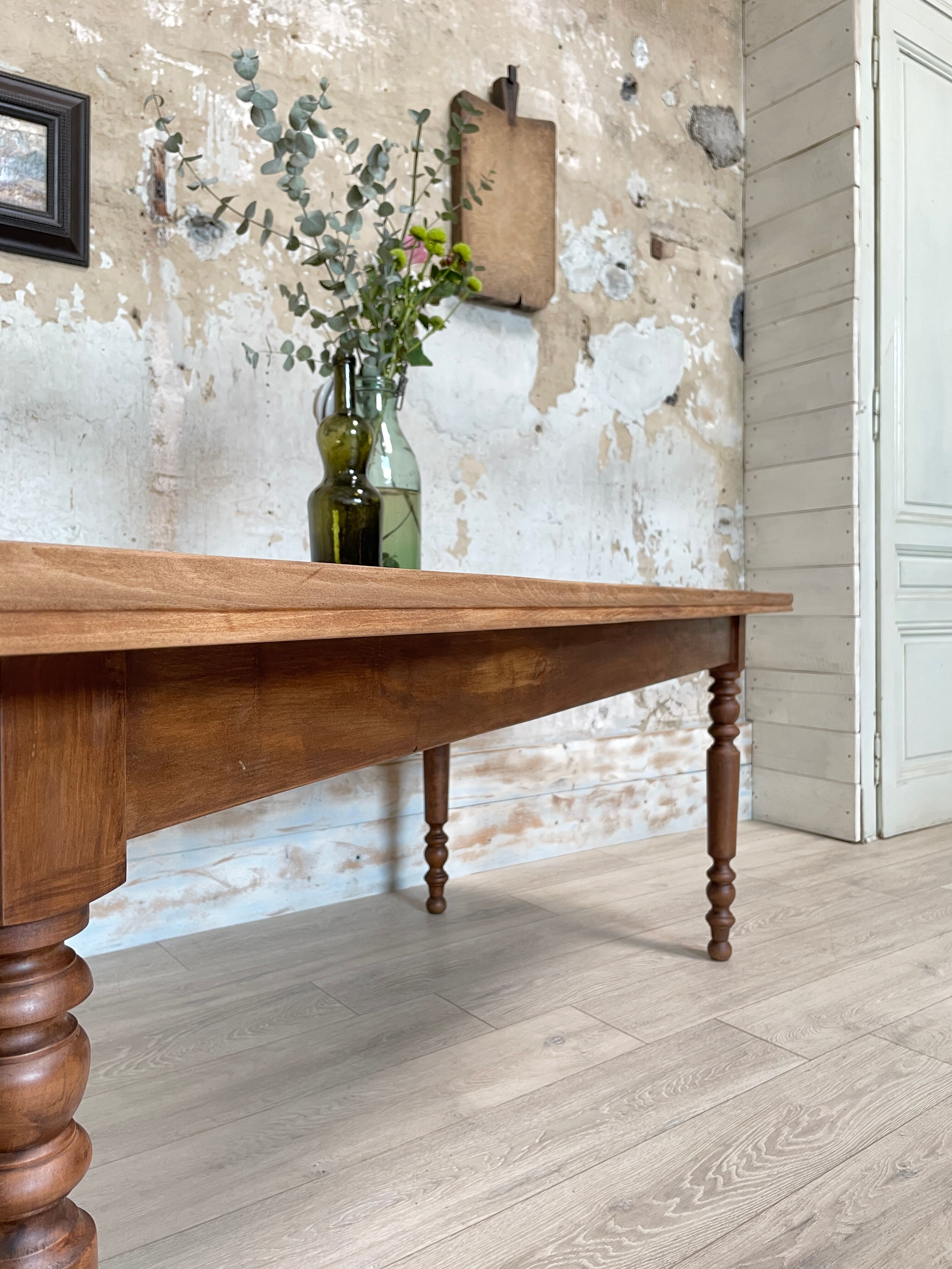 Vintage farmhouse table with turned legs.