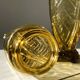 Duo of art deco vases in yellow glass with scroll patterns