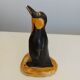 Small plaster penguin statue