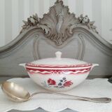 Mismatched old soup plates accompanied by a soup tureen