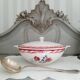 Mismatched old soup plates accompanied by a soup tureen