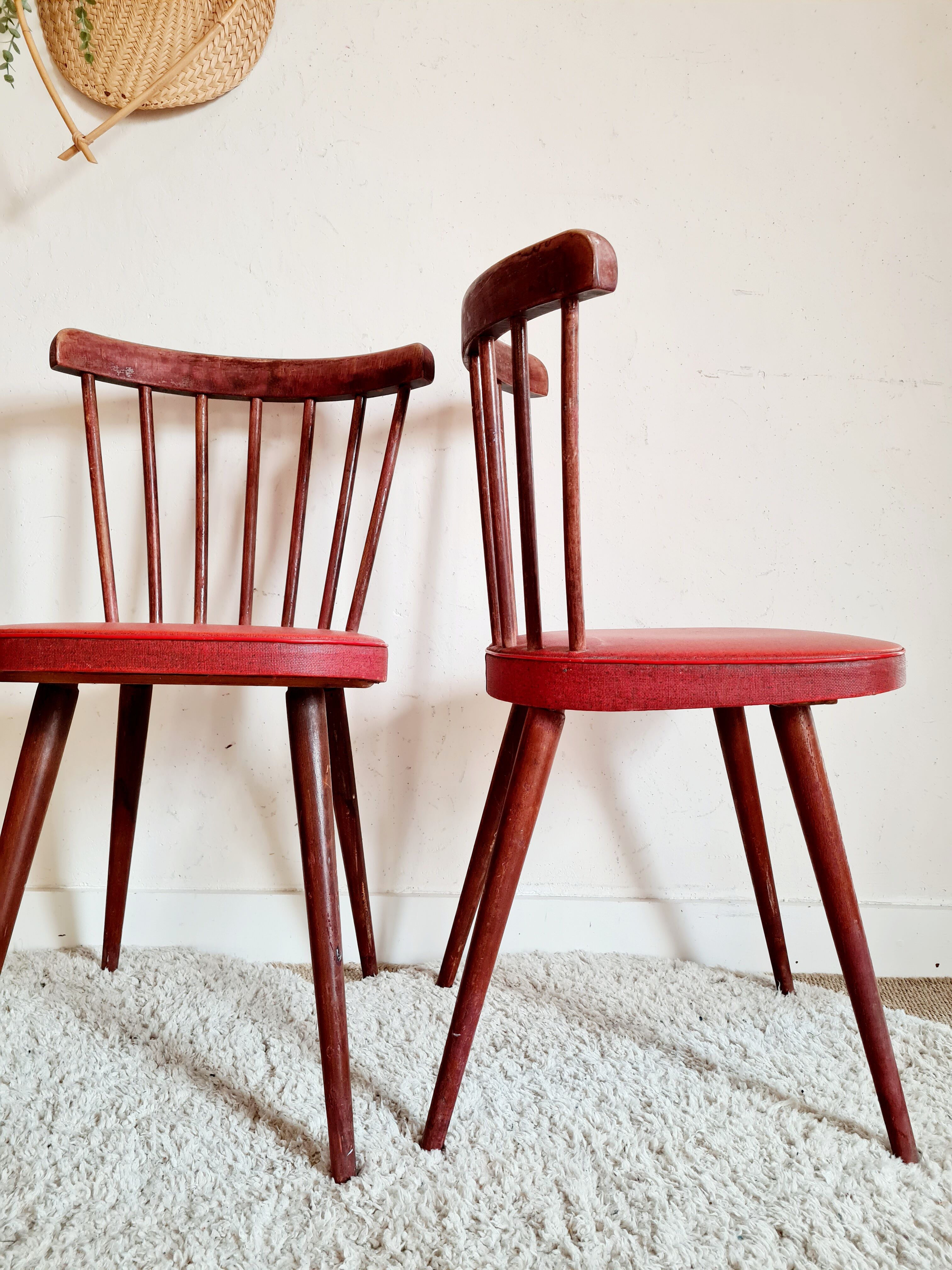Pair of wooden bistro chairs and red imitation seating