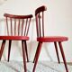 Pair of wooden bistro chairs and red imitation seating