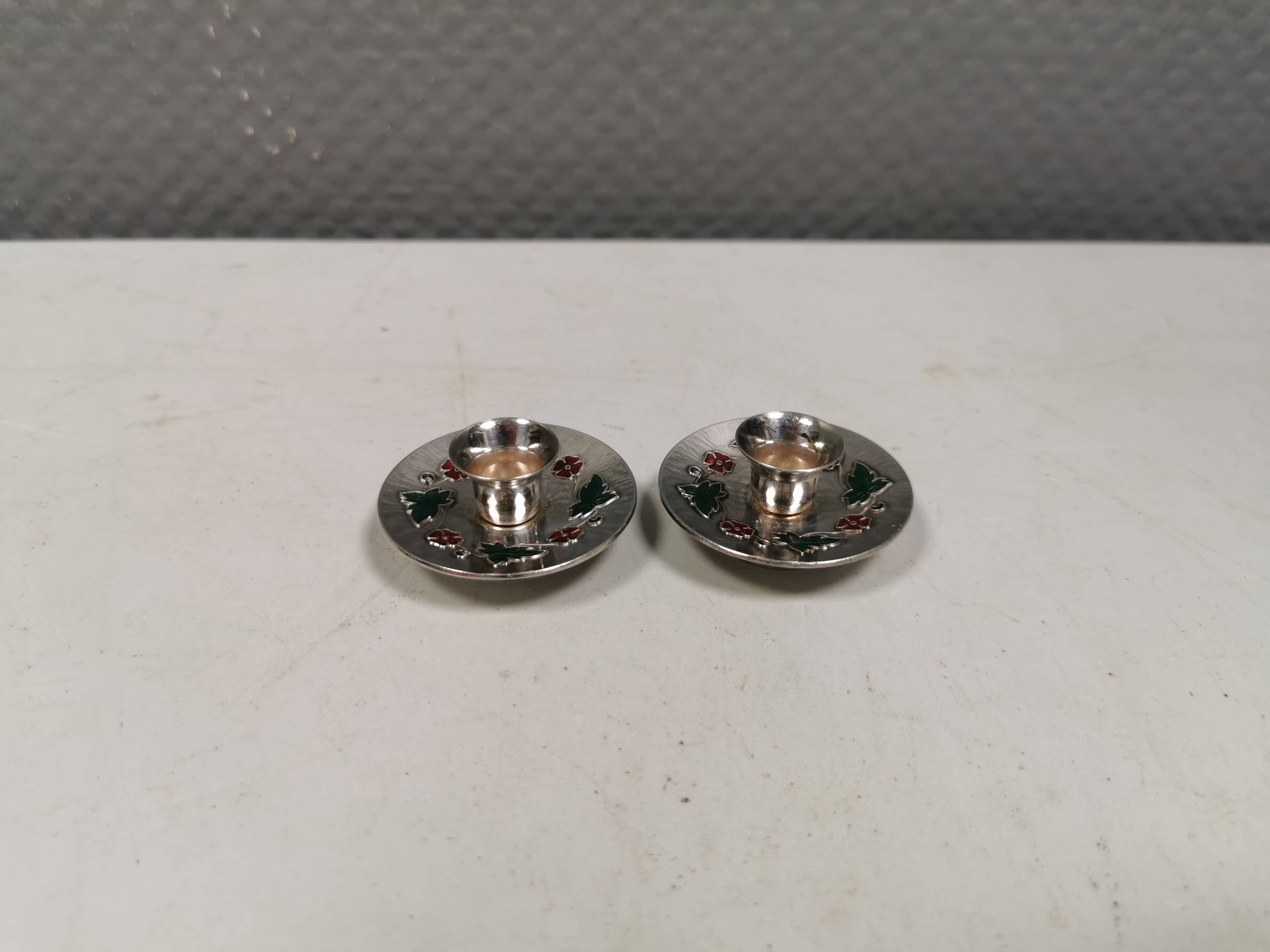 Silver-plated candle holders with inlaid red and green enamel