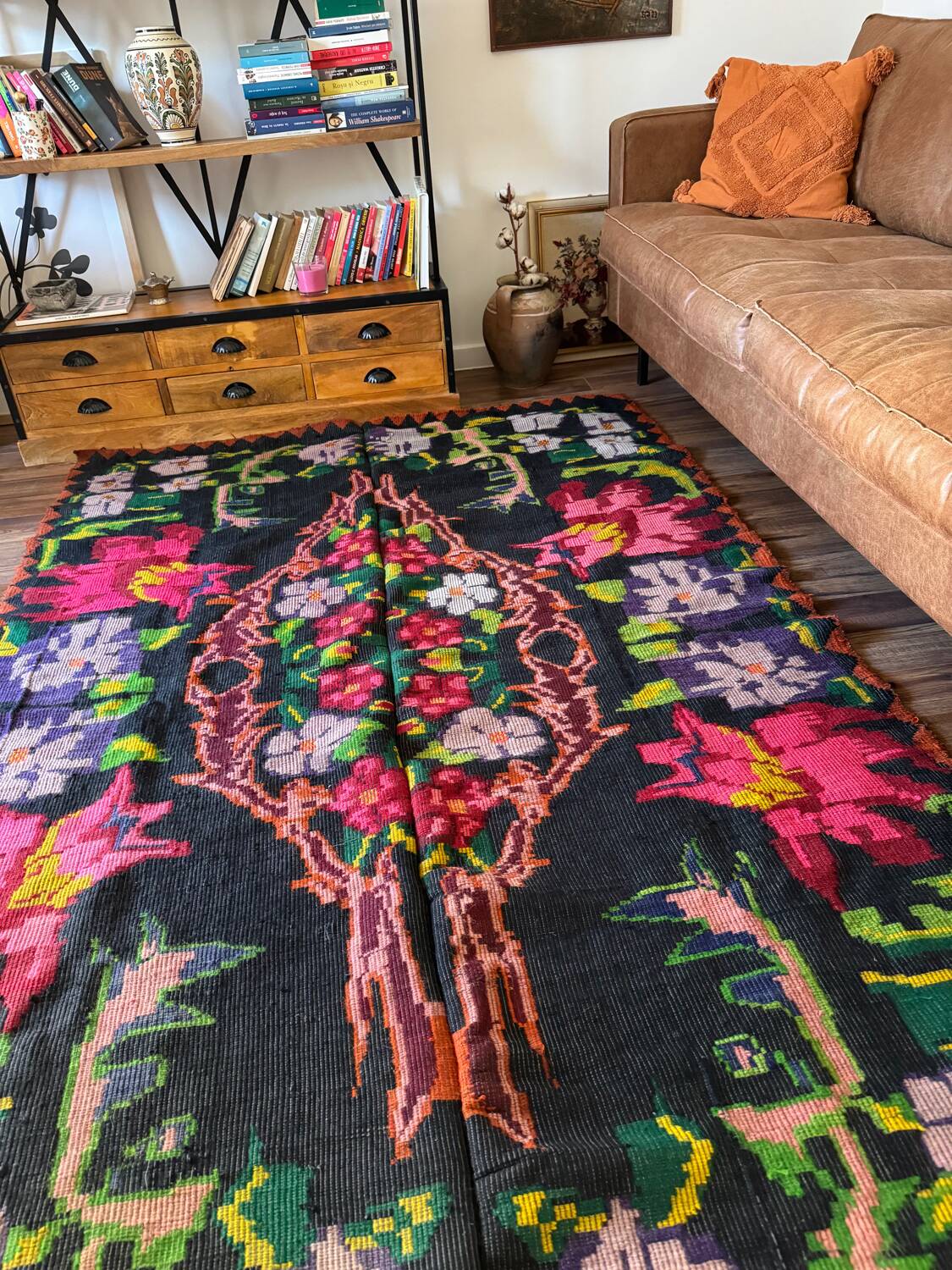 Bohemian floral design, handwoven wool rug, black background with colorful flowers