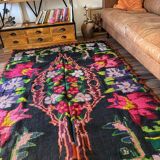Bohemian floral design, handwoven wool rug, black background with colorful flowers