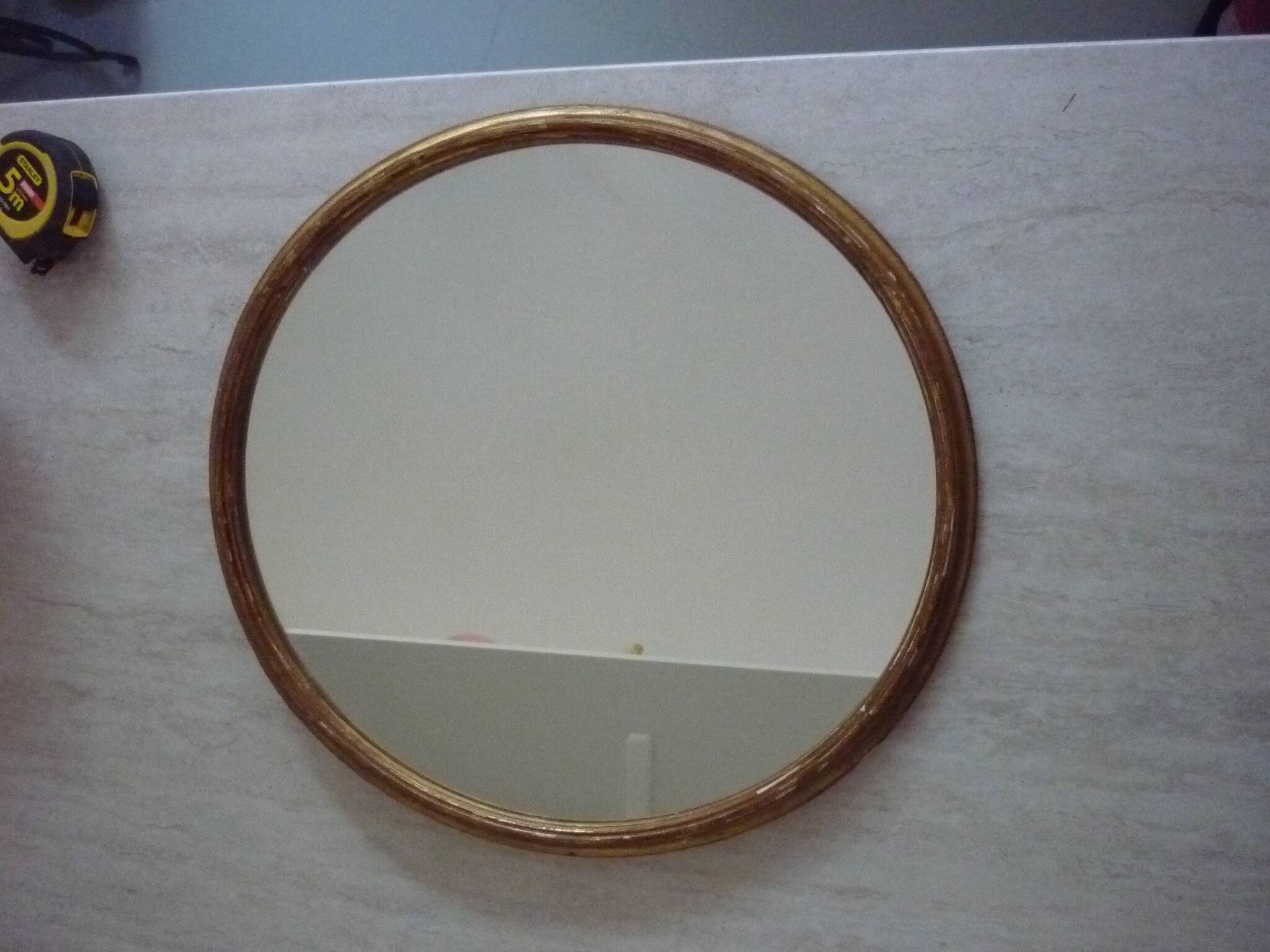 Old gilded wood oval mirror