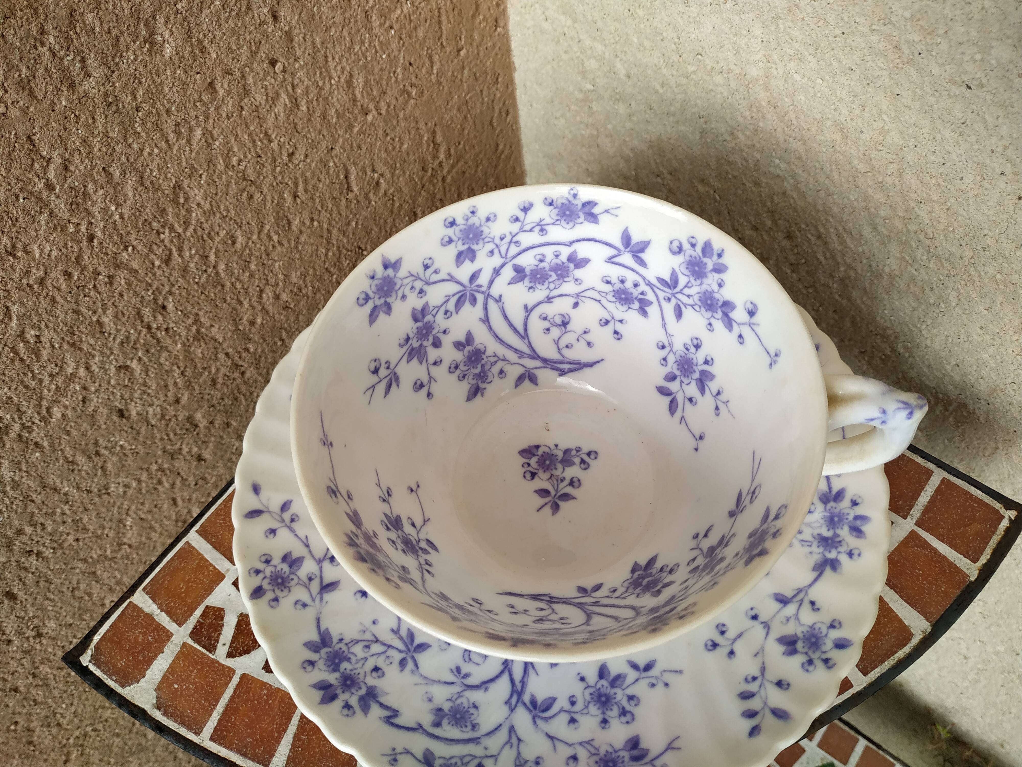 Ancient porcelain cup from eastern France with Mauve Fleurettes
