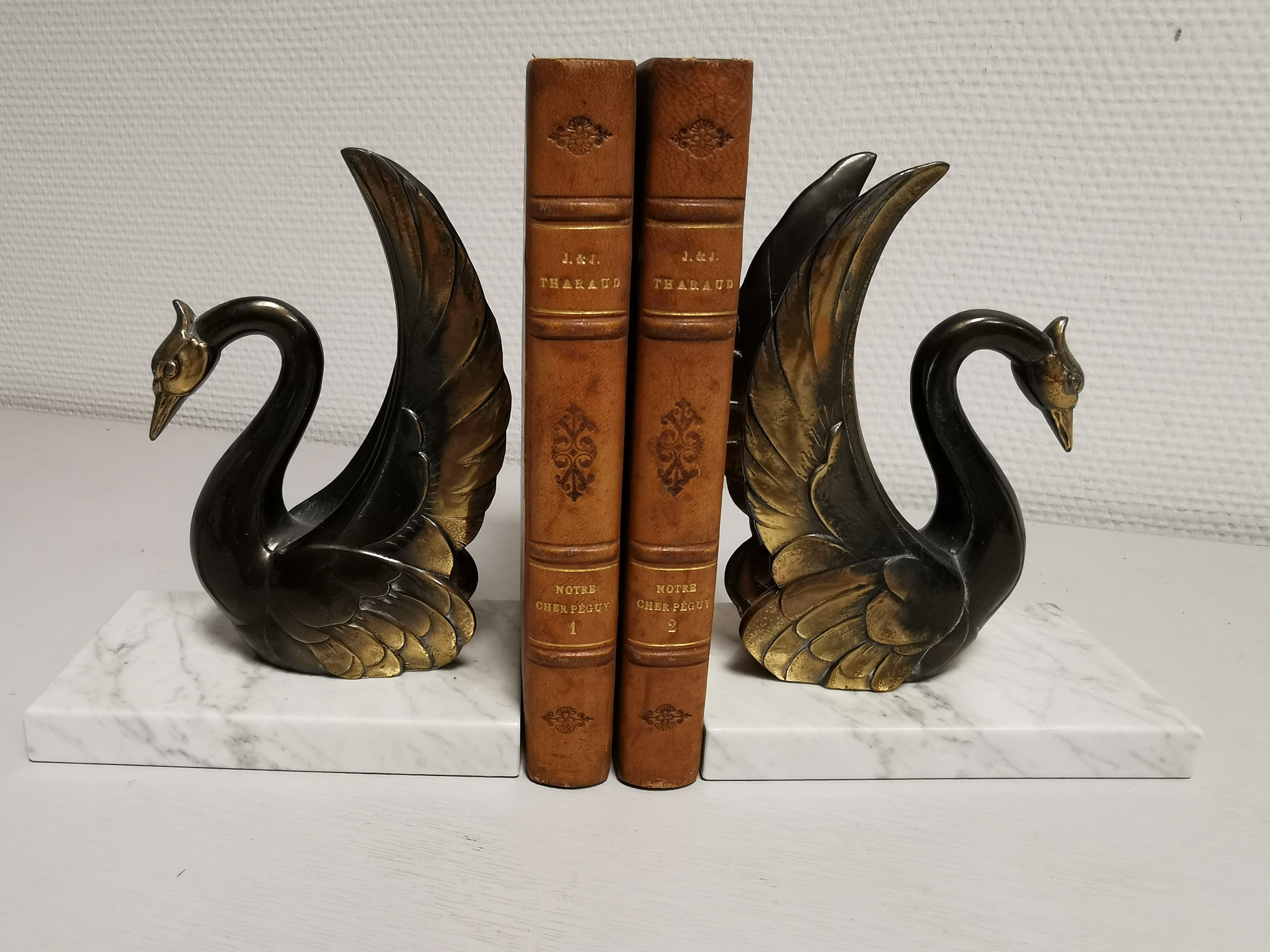 Pair of ancient zoomorphic bookends, swan statues