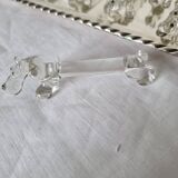 A charming set of 12 molded glass knives rests in the shape of a dog