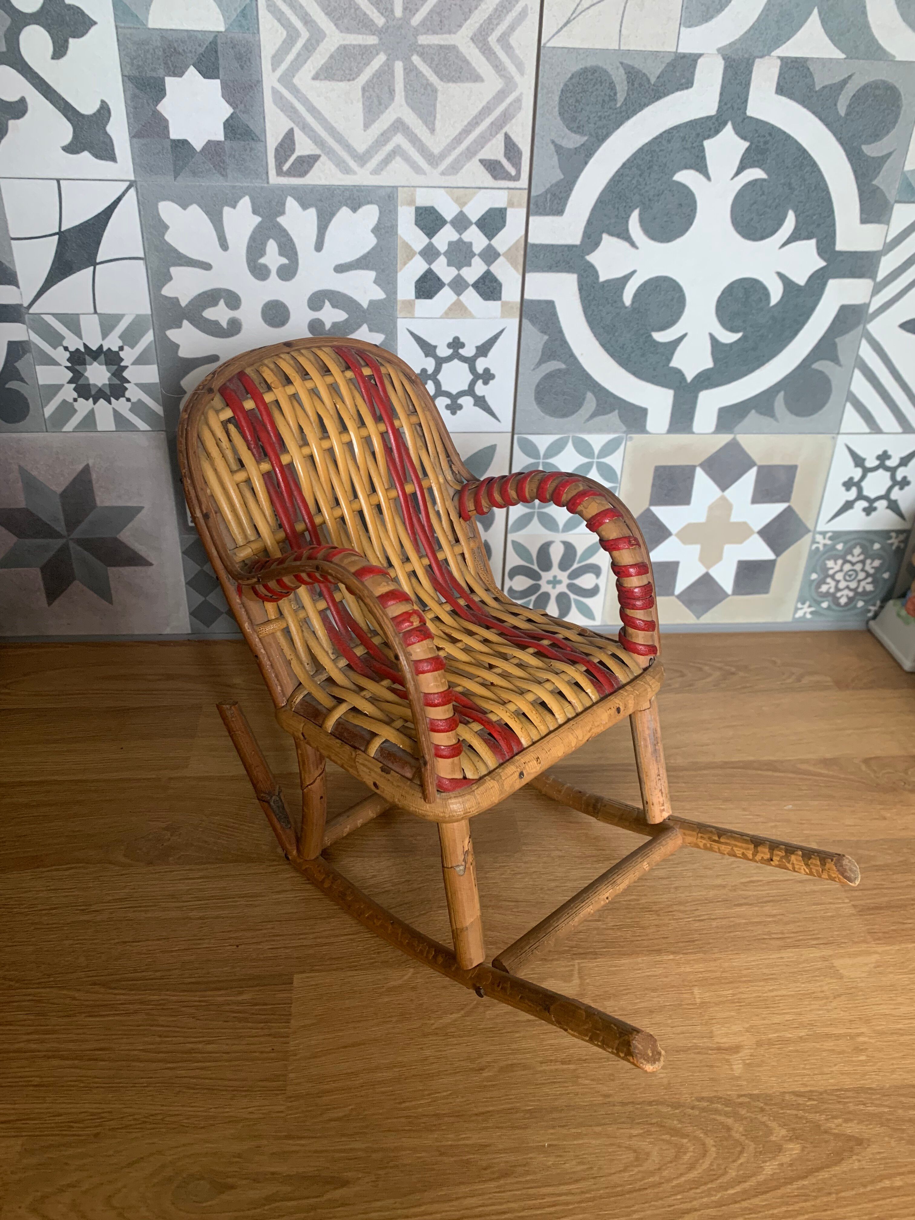 Antique miniature rocking chair in rattan for dolls.