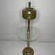 Vintage brass floor ashtray with glass shelf in Empire style.