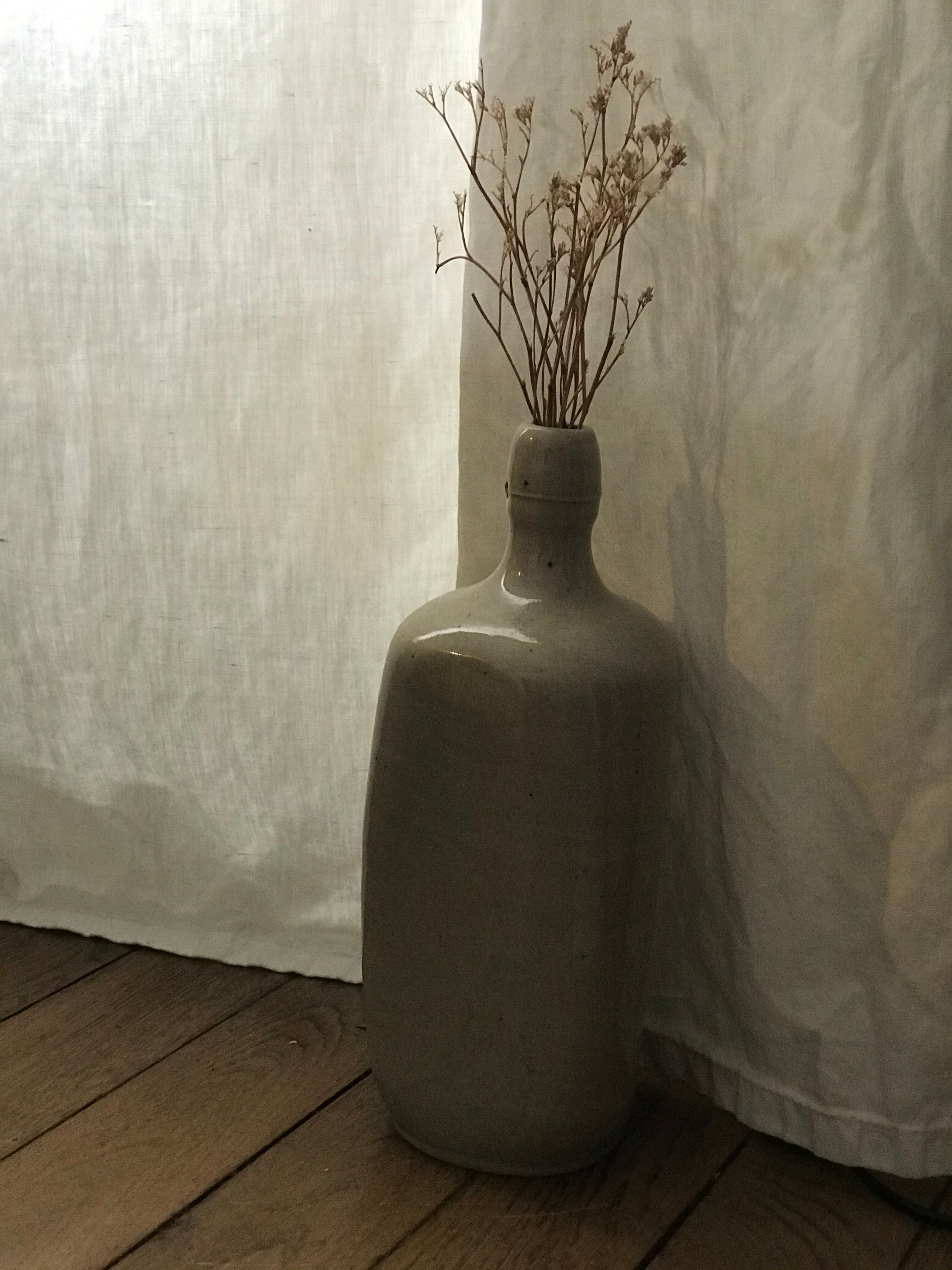 Old light grey ceramic bottle