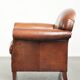Sheepskin armchair with comfortable seat and finished with decorative nails