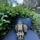 Brass magazine rack with baroque mask, wall-mounted match holder.