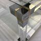 Coffee table in plexiglass, brass and glass top, 1980.