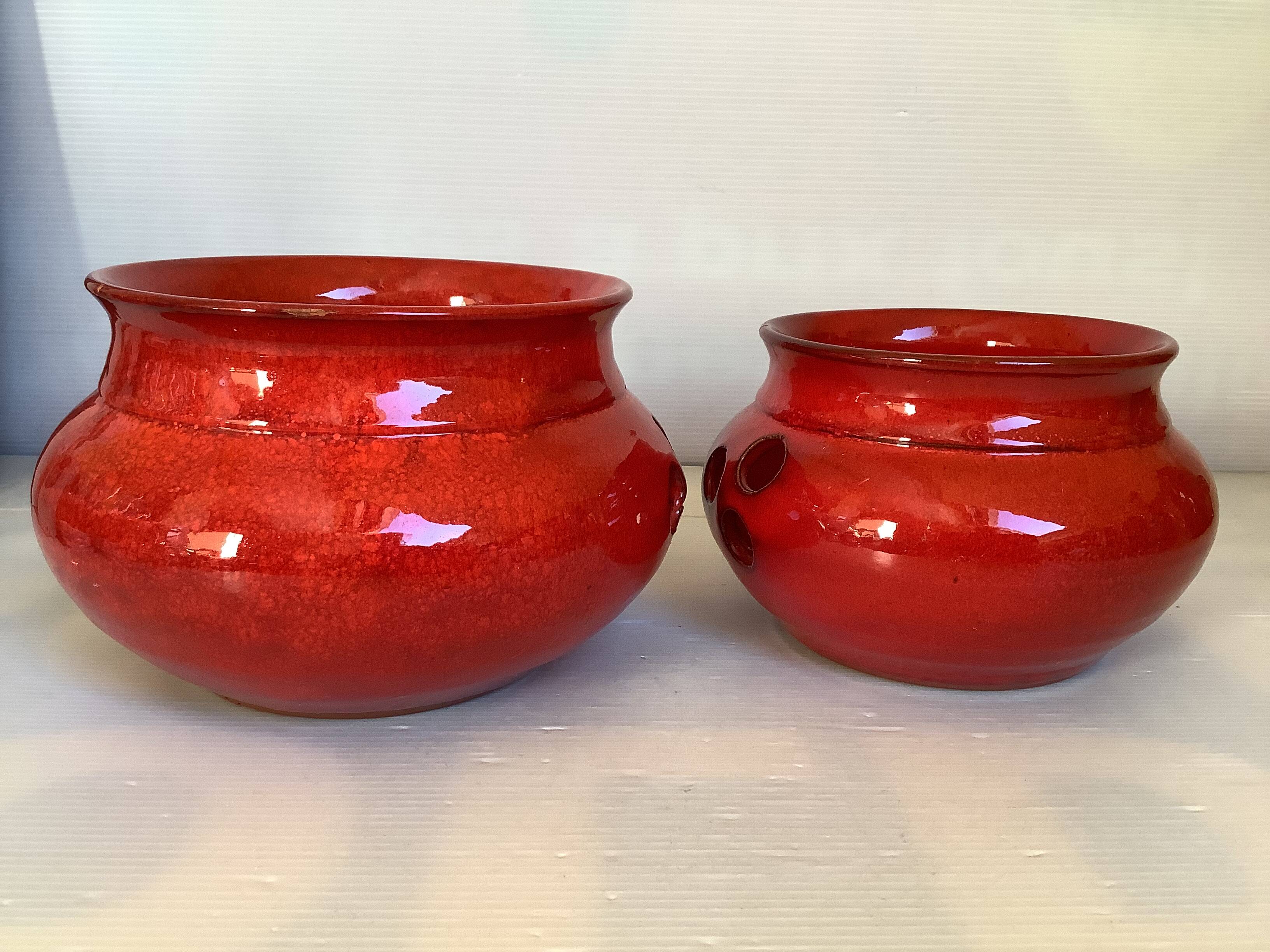 Pair of red Scandinavian candle holders.