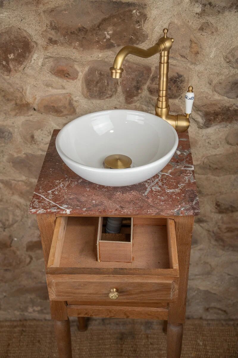 Small antique washbasin in wood and red marble.