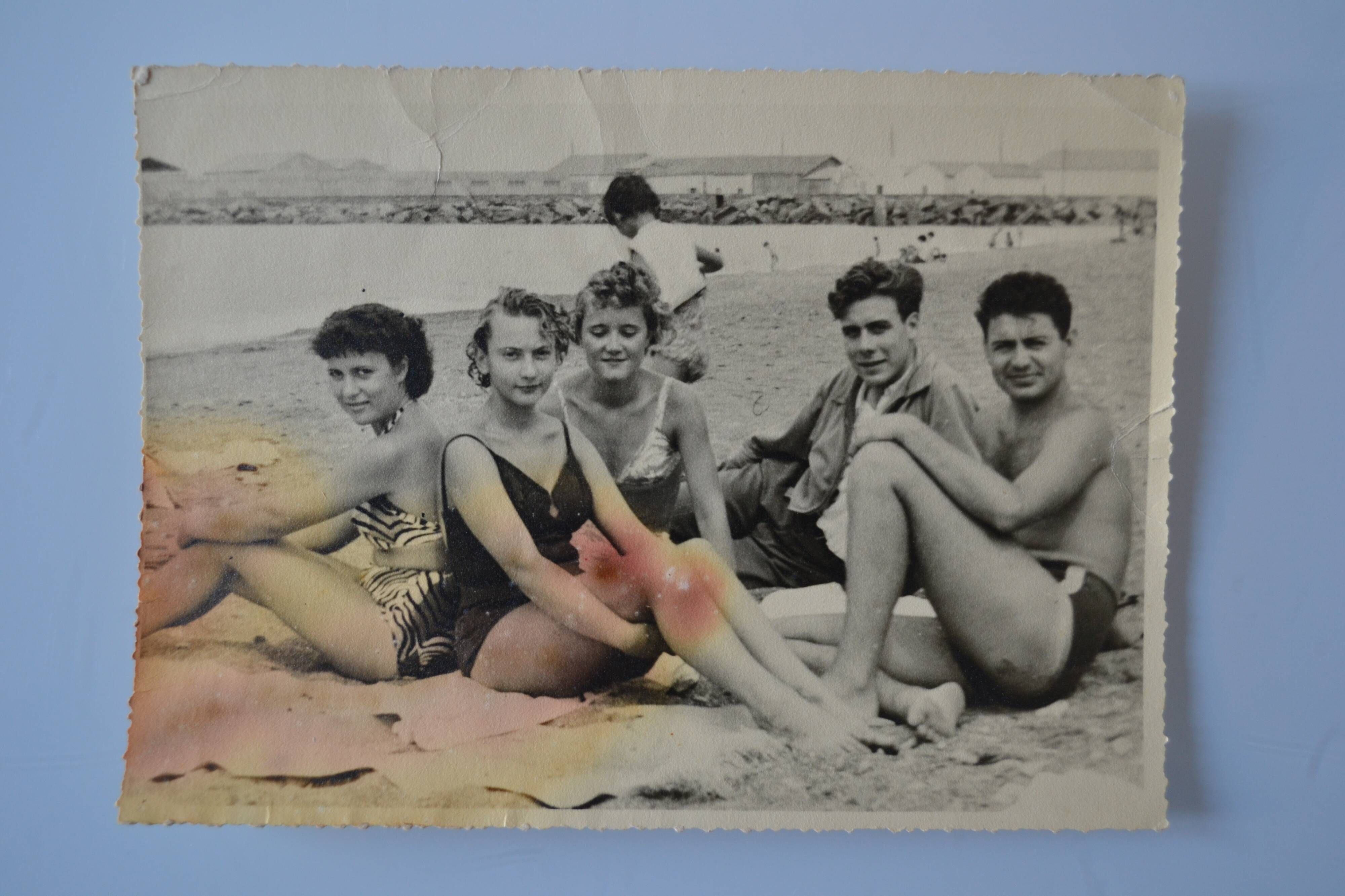 Old film photo circa 1950 the beach group of teenagers