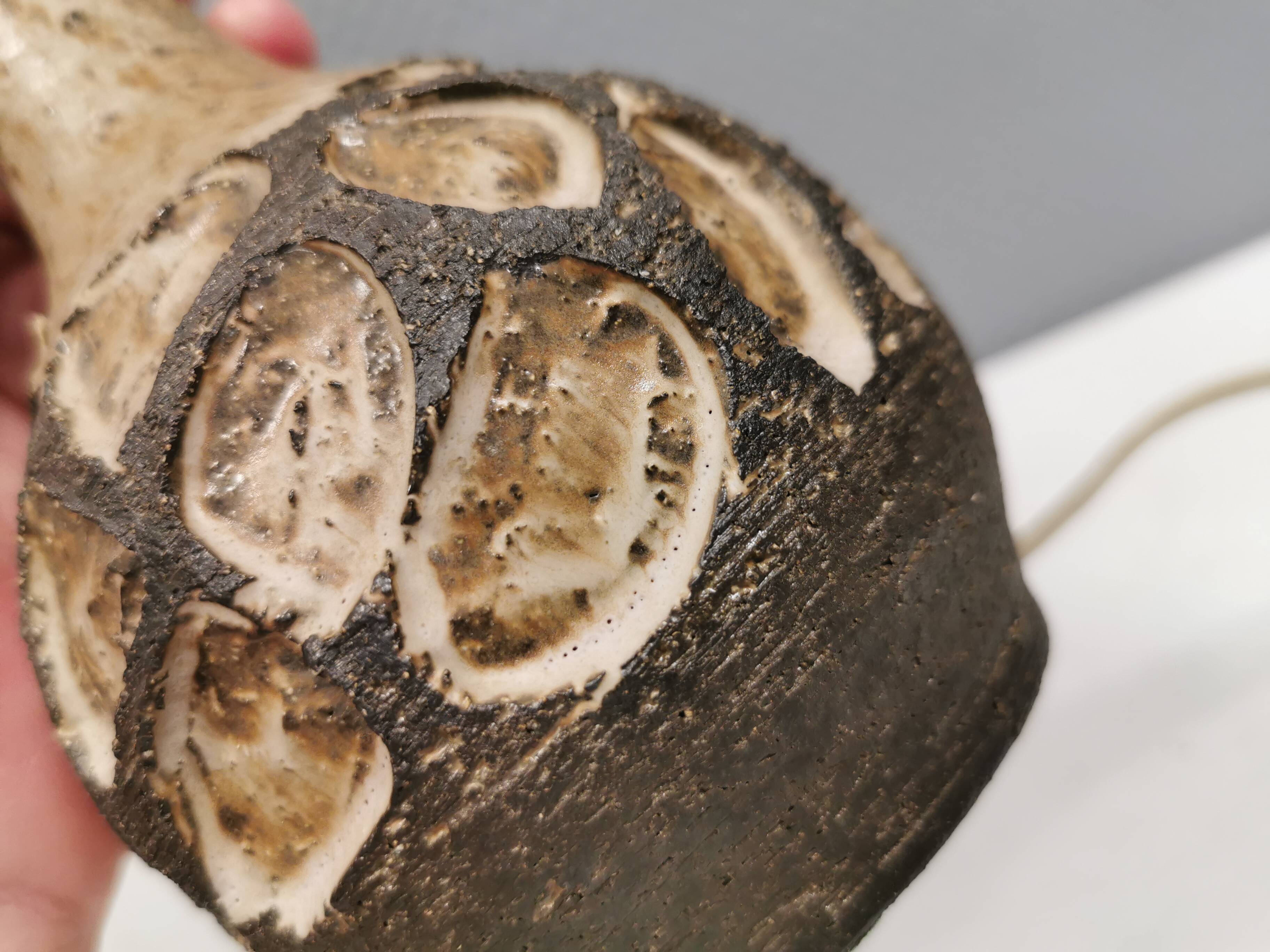 Small beautiful ceramic table lamp in earth colors.