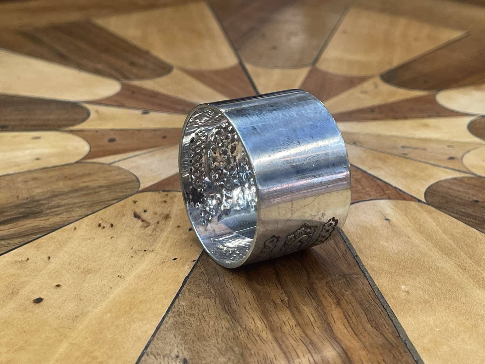 Silver metal napkin ring with the letter J