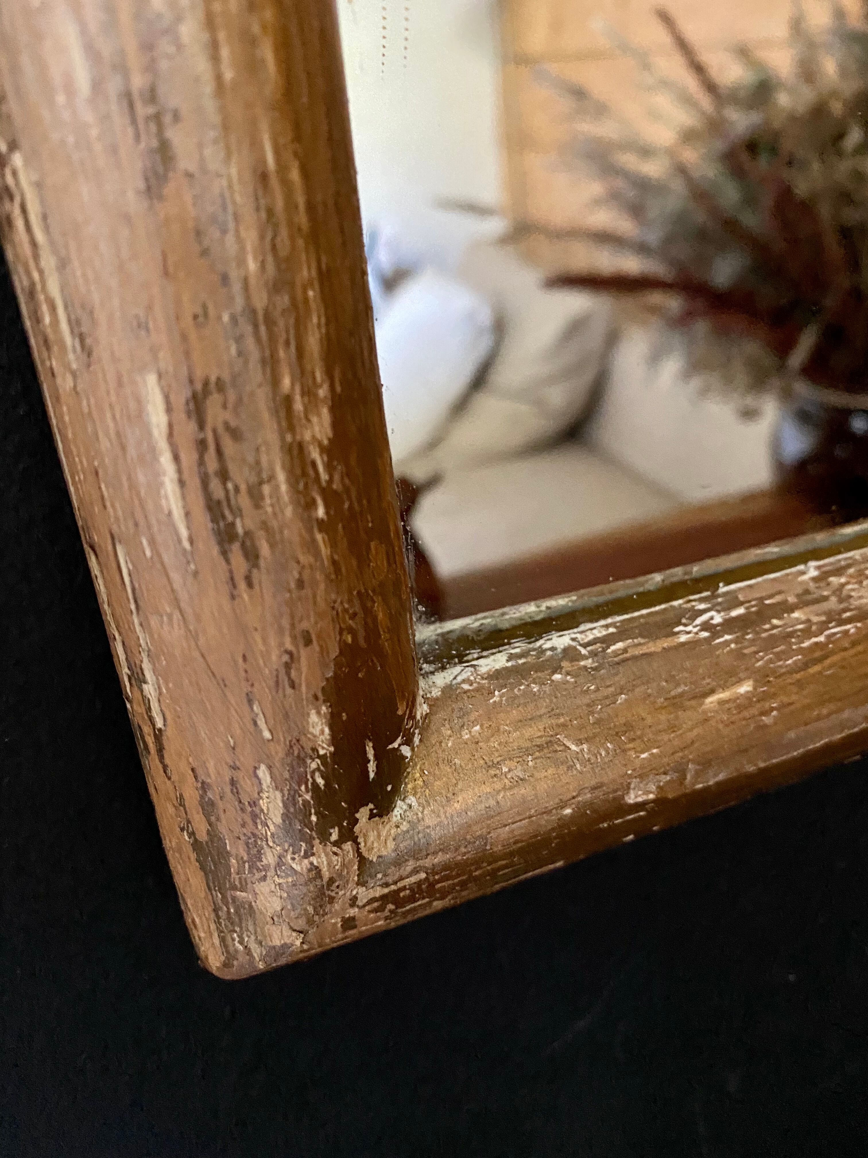 Patinated gilded mirror in wood and plaster