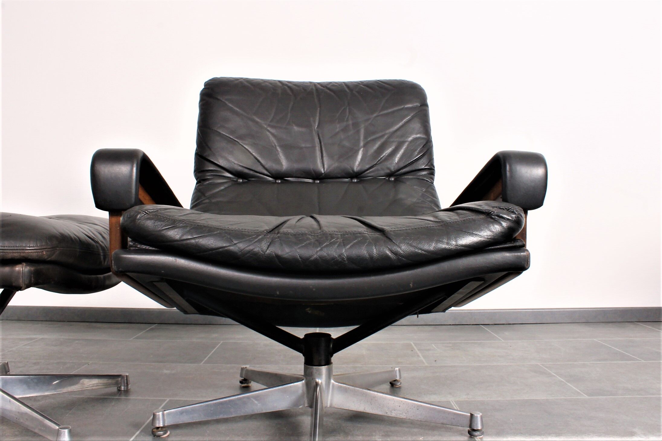 Armchair and footstool by André Vandenbeuck for Strässle in black leather