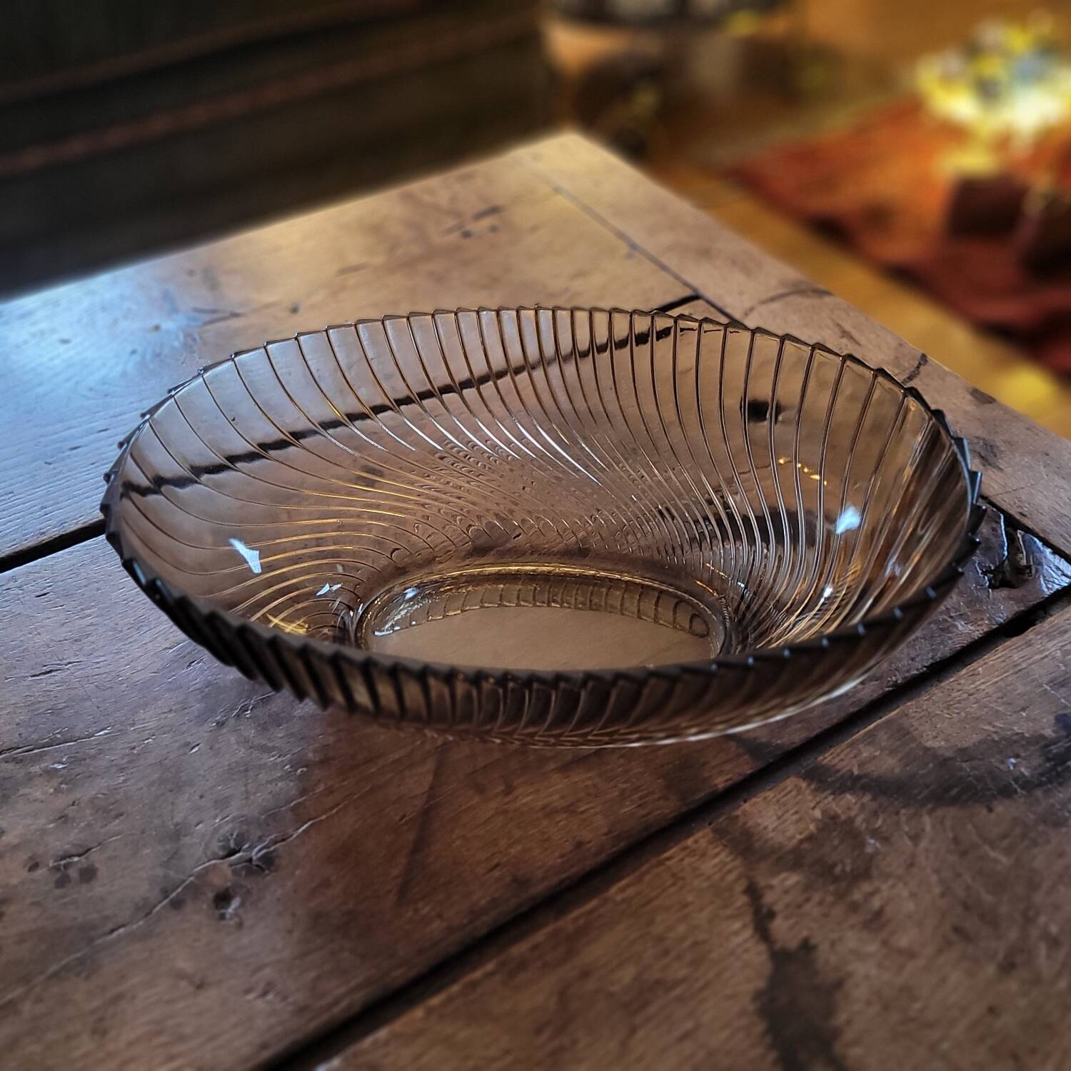 Smoked glass bowl with a radiating embossed pattern — 1970s