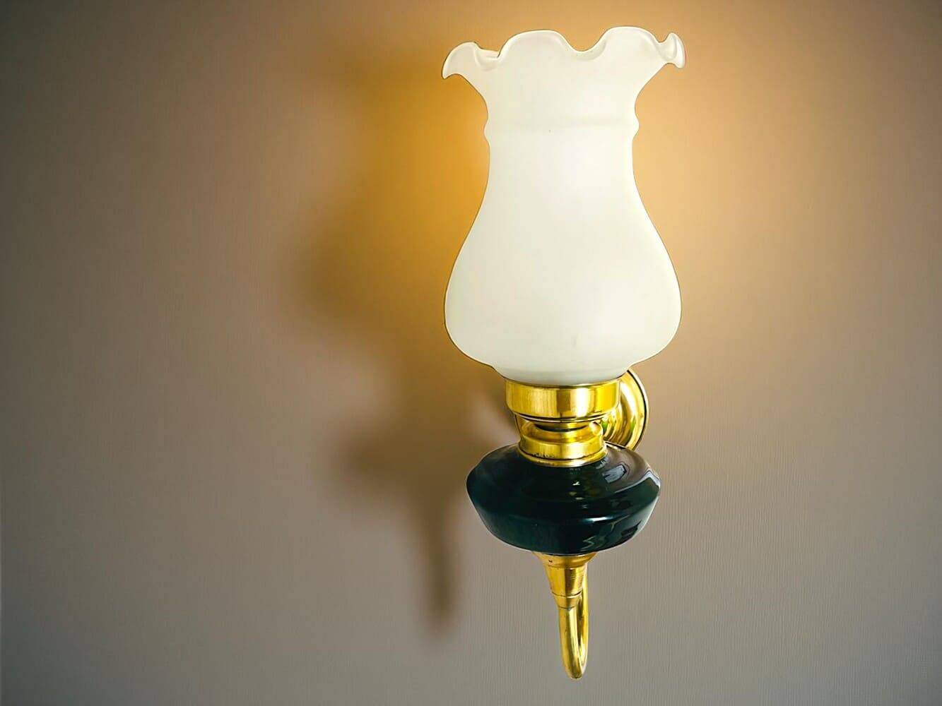 Brass wall sconce with frosted glass tulip lampshade
