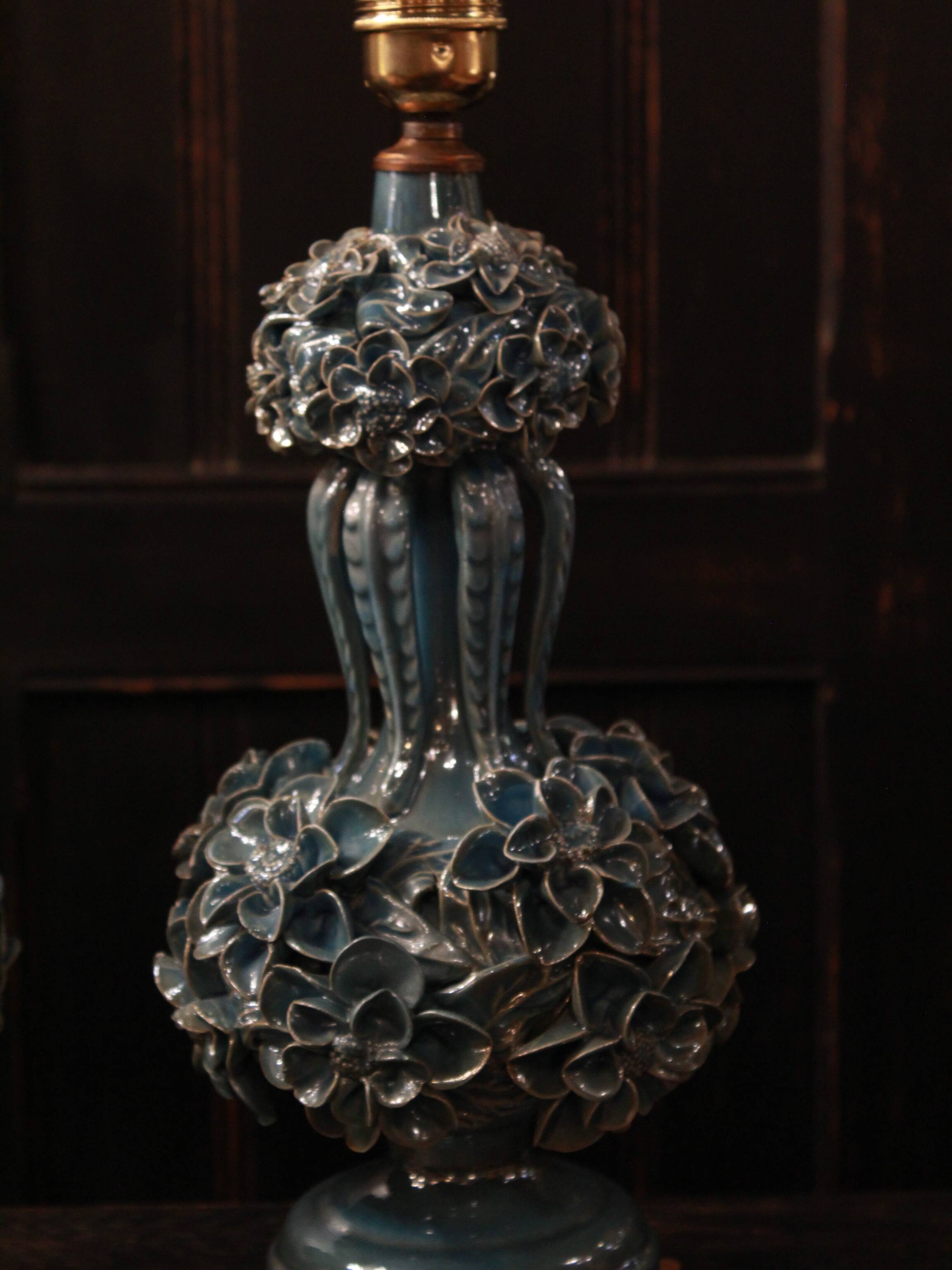 Pair of iridescent light blue lamps, featuring a floral bush design