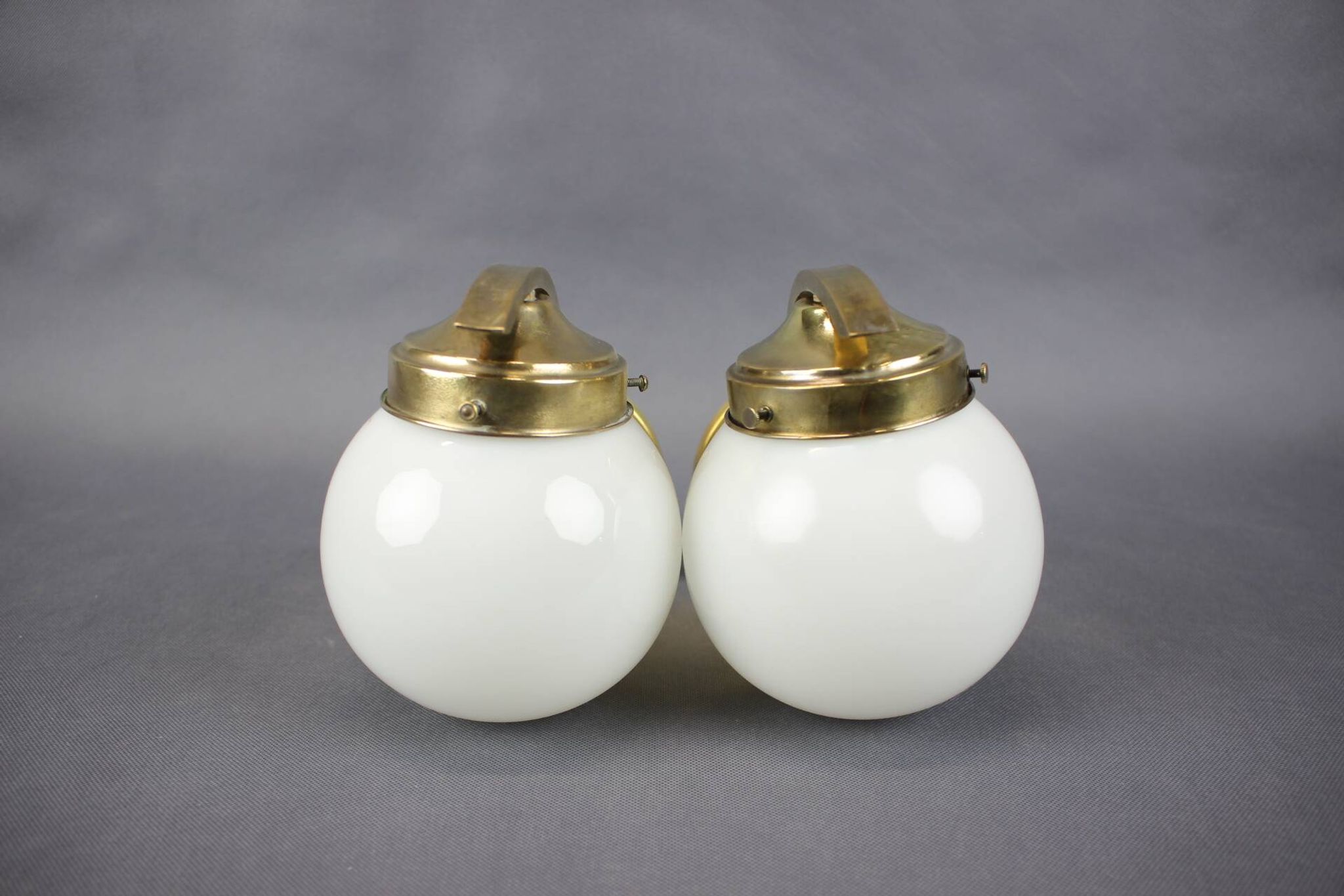 Pair of Art Deco wall sconces in brass and opaline glass, Europe, 1930s