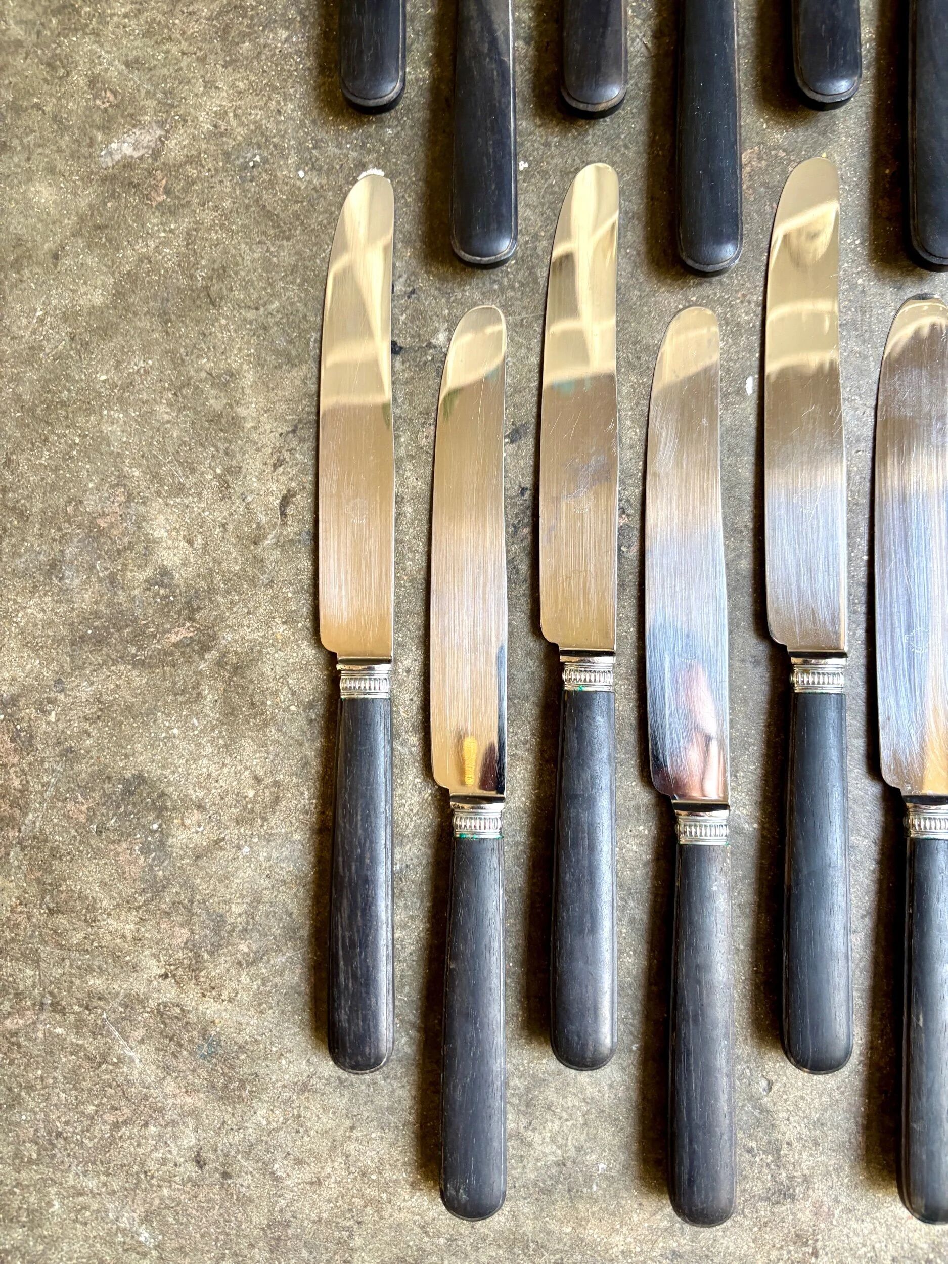 12 blackened wooden knives