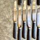 12 blackened wooden knives
