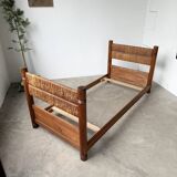 Brutalist style bed with chain and straw