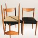 Set of 6 modernist chairs with black faux leather seats.