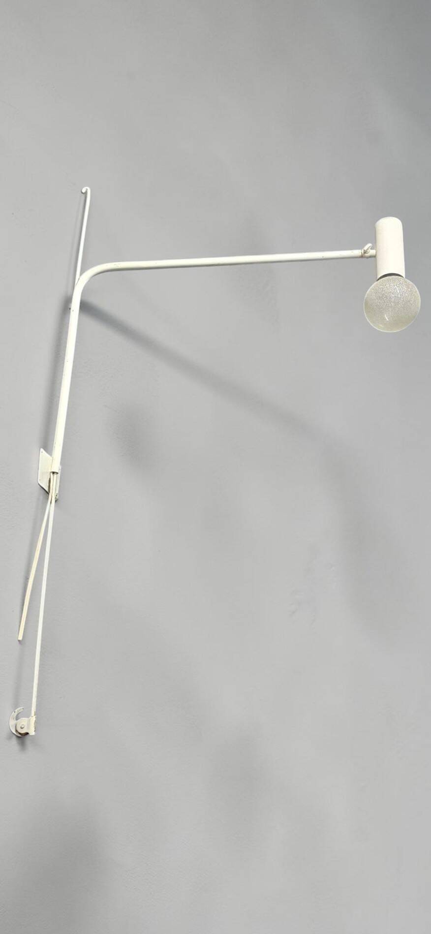Minimalist metal wall light in the style of Jean Prouvé, circa 1950.
