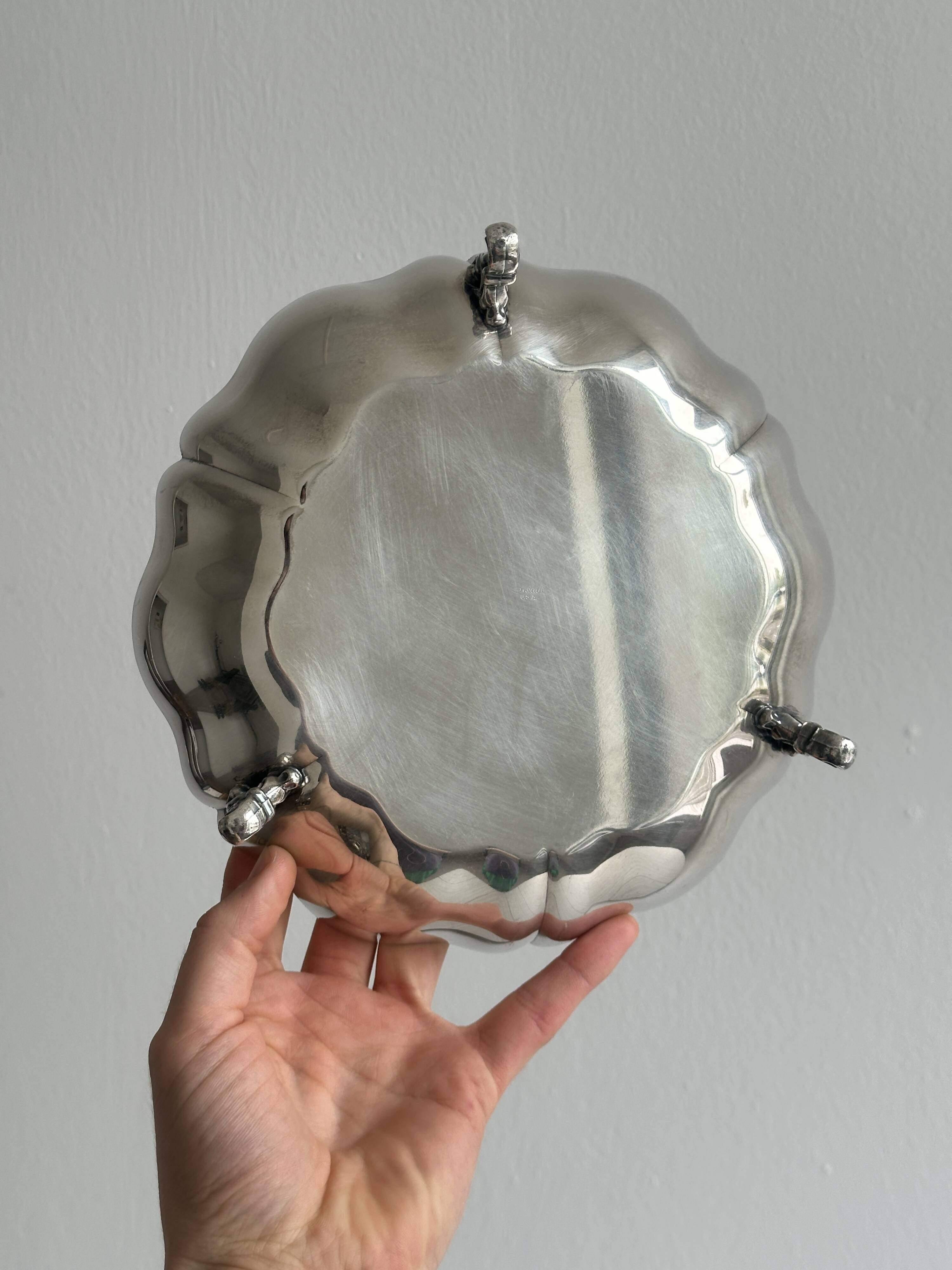 Silver-plated metal basket on rockwork feet