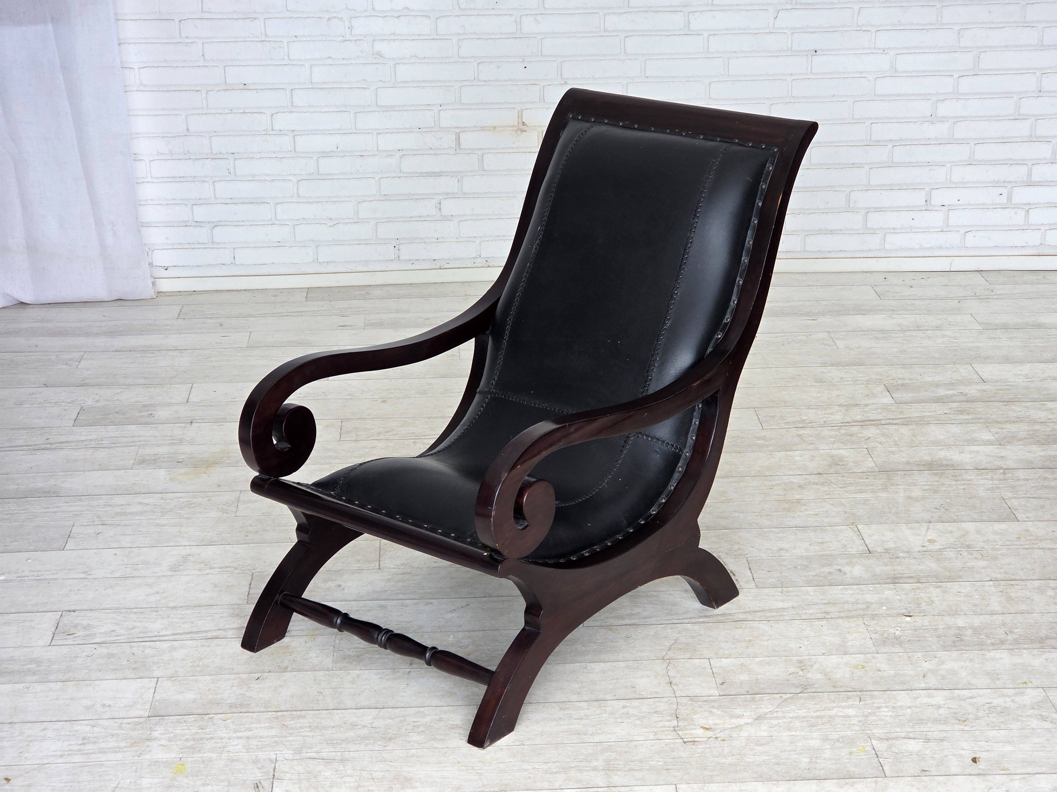 1970s, vintage armchair with footstool, black furniture leather.