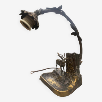 Metal table lamp with a deer on the front