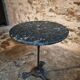 Old French bistro table with a marble top and a cast iron base.