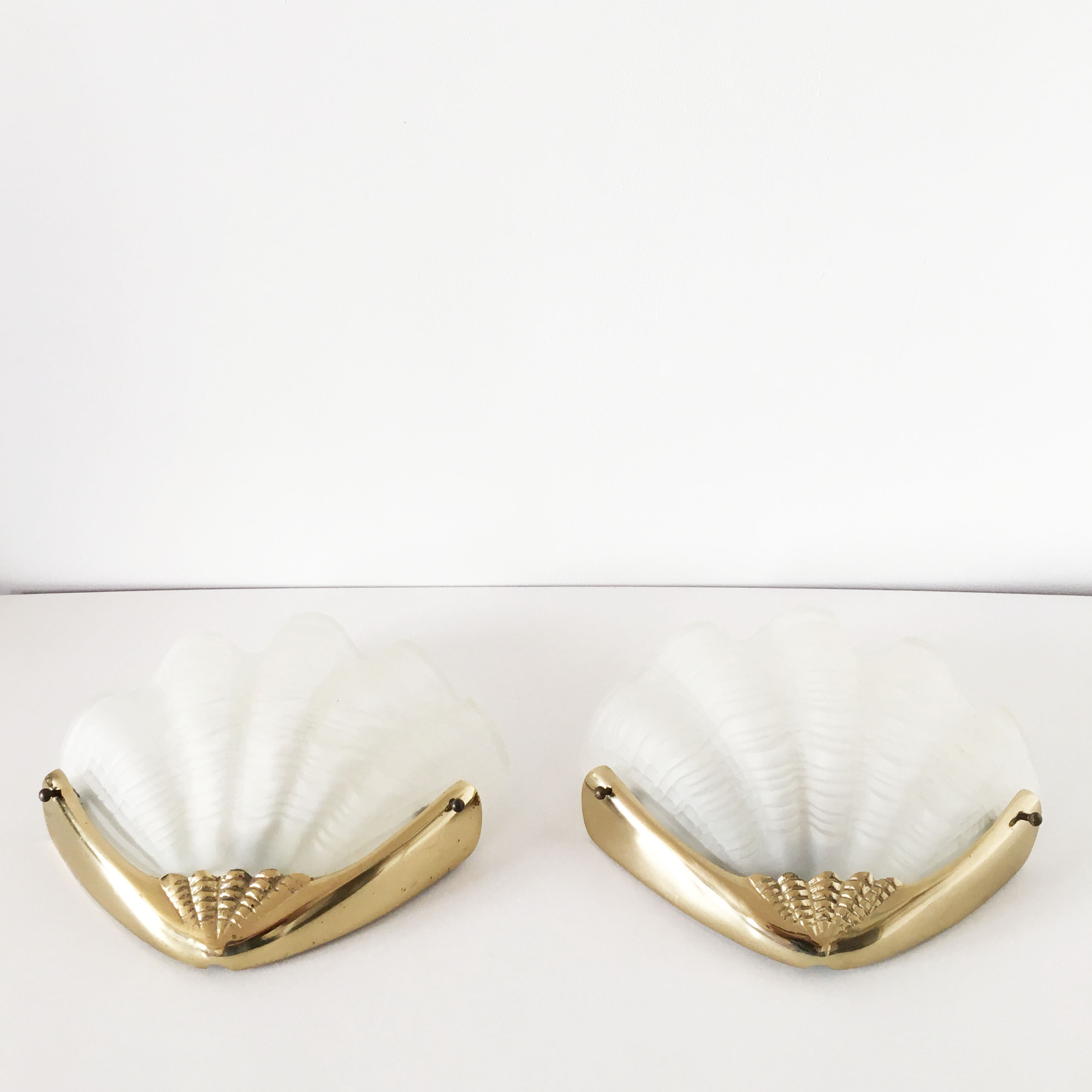 Pair of glass and gold metal shell sconces
