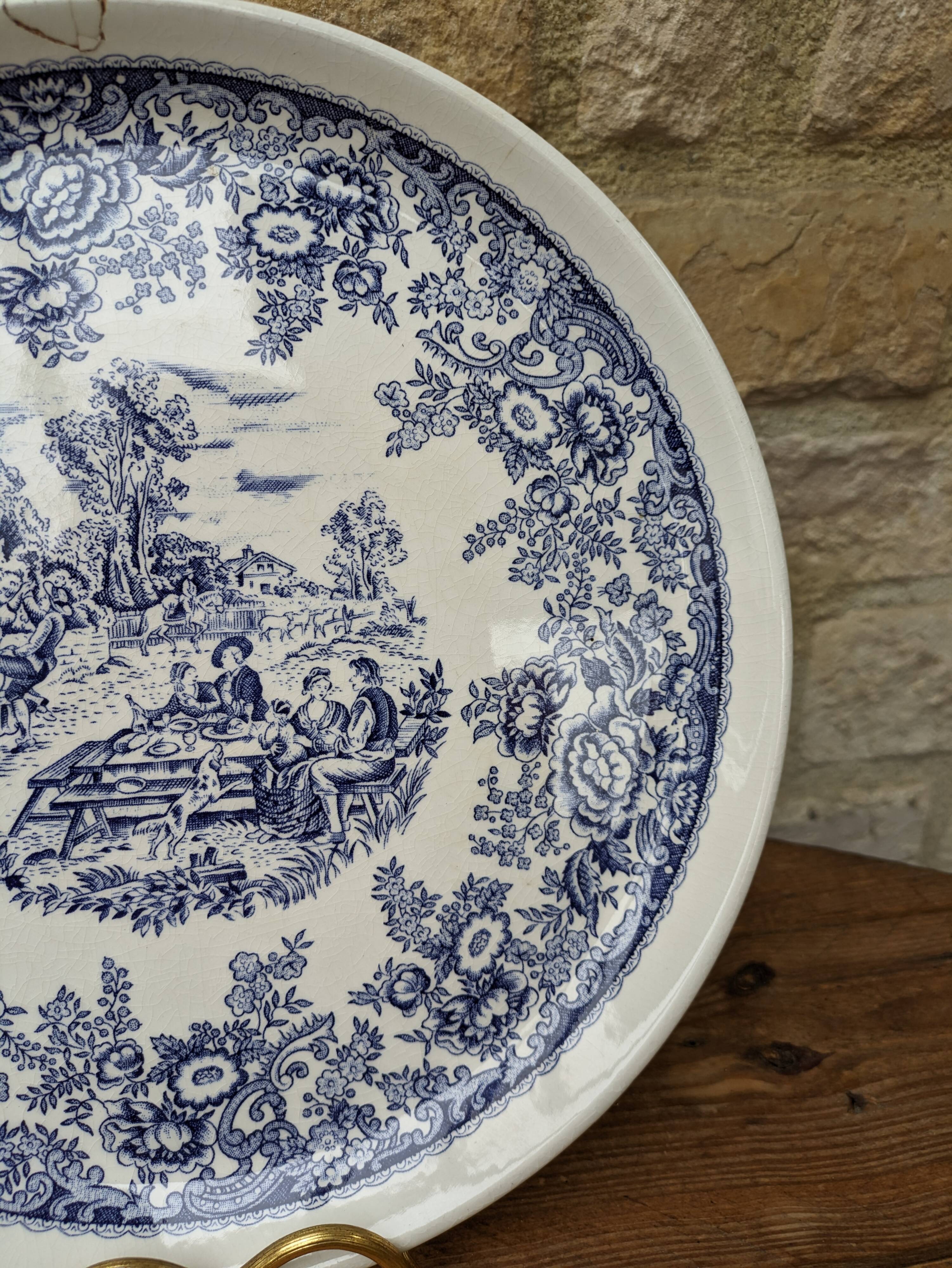 Old ceramic plate with scene of life and blue floral decor Van Melle