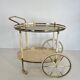 Italian oval rolling table in brass and lacquered wood.